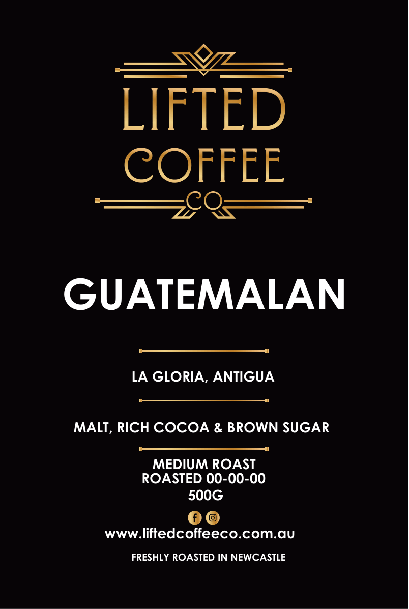 A flat product label or packaging design for Lifted Coffee Guatemalan, featuring a solid black background with elegant gold and white typography detailing the coffee origin, roast, and website.